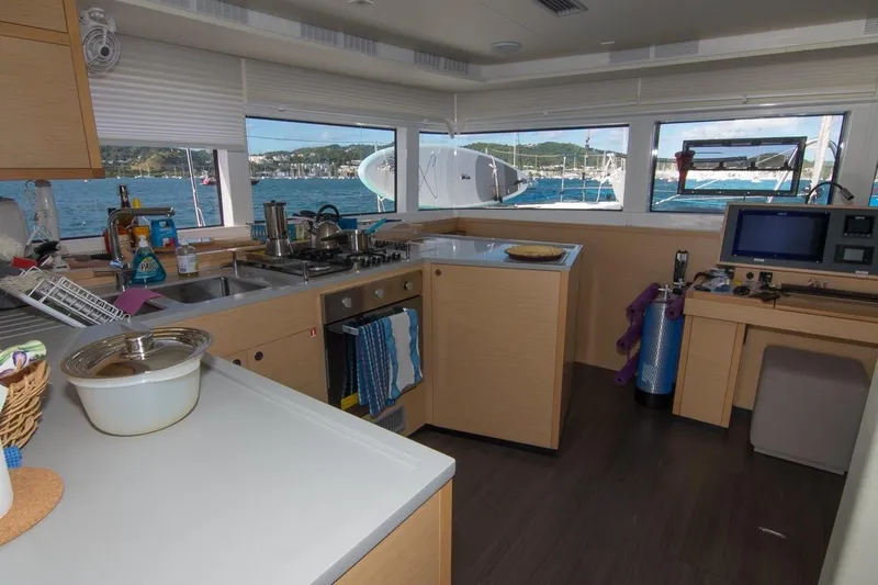 Oui Cherie Yacht Photos Pics Interior of 2017 Lagoon 52 F yacht kitchen with ocean view through windows.