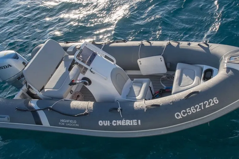 Oui Cherie Yacht Photos Pics Inflatable boat on water, labeled "Oui-Chérie," with Honda motor, associated with Lagoon 52 F, 2017.