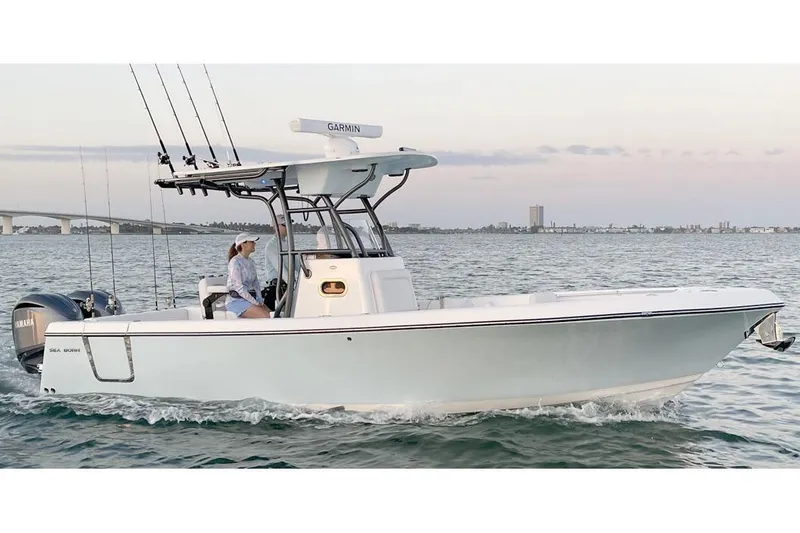  Yacht Photos Pics Manufacturer Provided Image: 2025 Sea Born LX26 Center Console boat cruising on water with fishing rods.