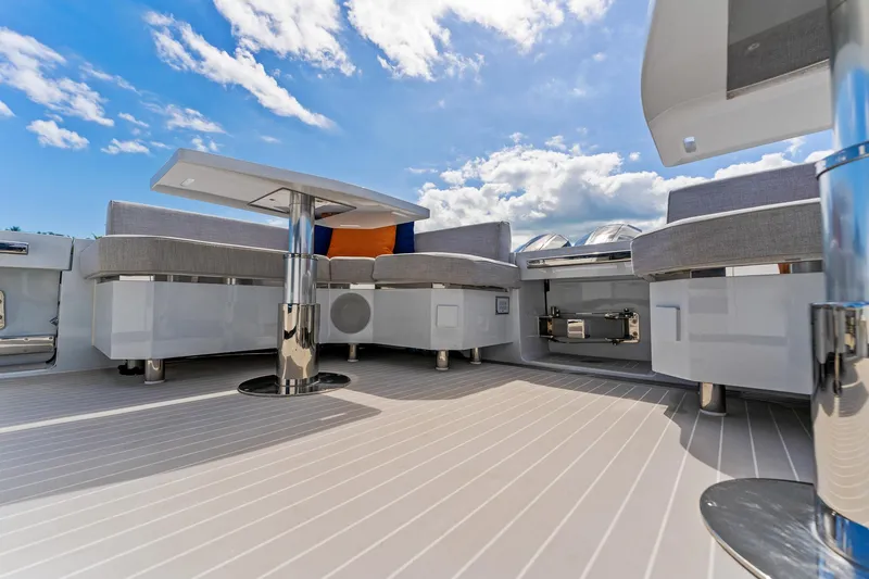  Yacht Photos Pics 2024 Uniesse Exuma HTC5p yacht deck with modern seating and table under blue sky.