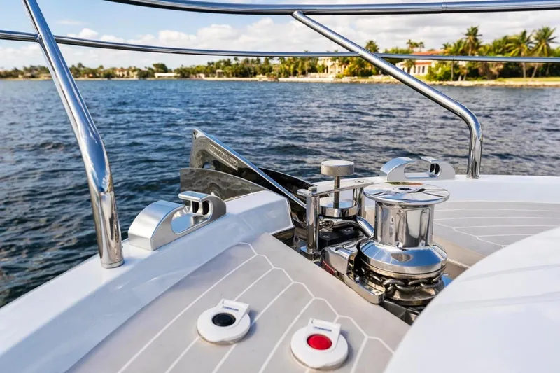  Yacht Photos Pics 2024 Uniesse Exuma HTC5p yacht deck with chrome fittings, ocean view, and distant shoreline.