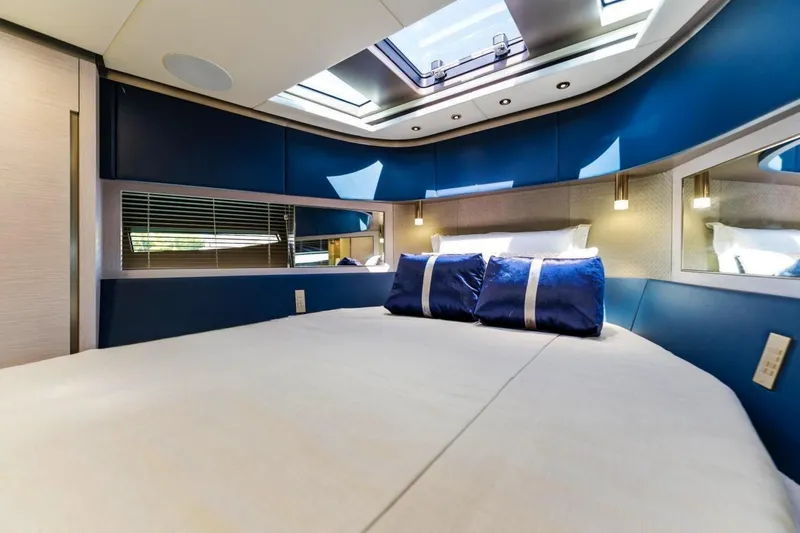  Yacht Photos Pics Luxurious interior of 2024 Uniesse Exuma HTC5p yacht with elegant bedding and skylight.