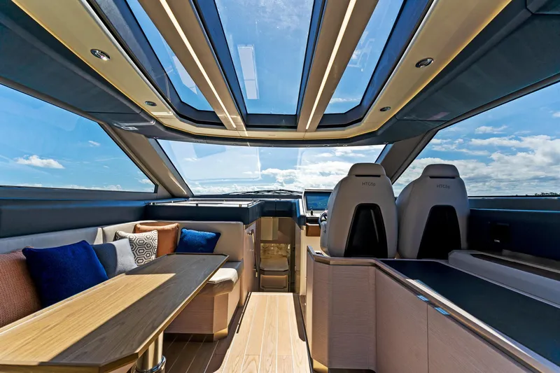  Yacht Photos Pics Luxurious interior of 2024 Uniesse Exuma HTC5p yacht with panoramic windows and elegant seating.