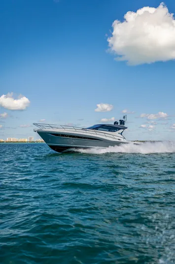  Yacht Photos Pics 2024 Uniesse Exuma HTC5p yacht cruising on open water under a clear blue sky.