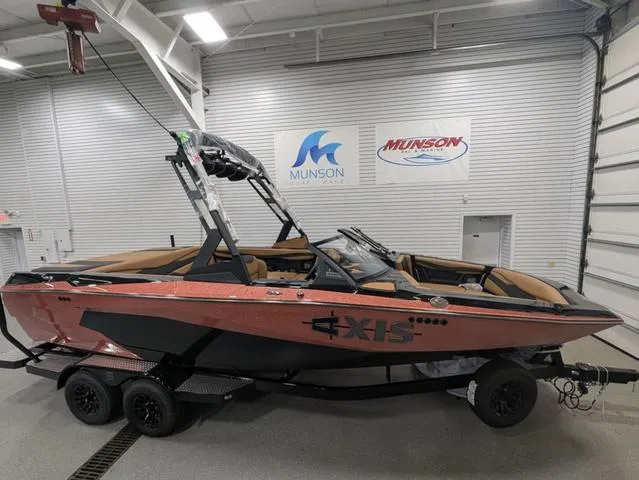 2025 Axis Wake Research A225 boat in showroom, featuring sleek design and modern features.