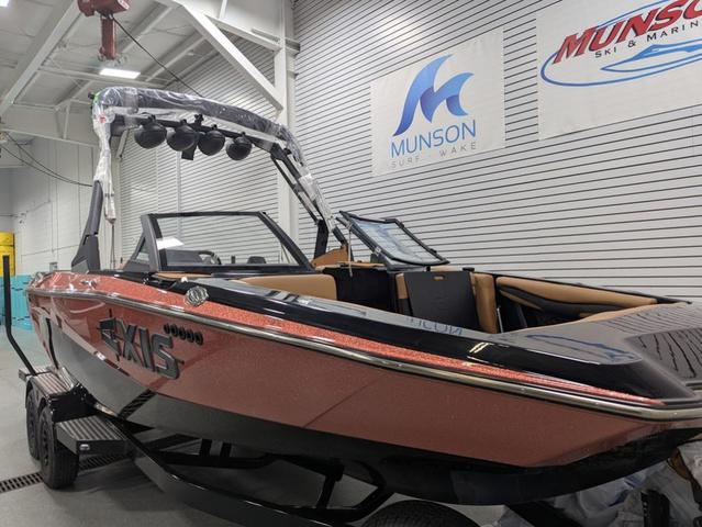 2025 Axis Wake Research A225 boat in showroom, Munson Surf & Wake signage visible.