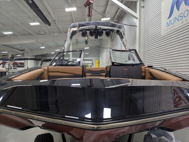 2025 Axis Wake Research A225 boat in showroom, featuring sleek design and spacious seating.