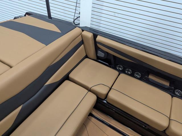 2025 Axis Wake Research A225 boat interior with tan and black seating.