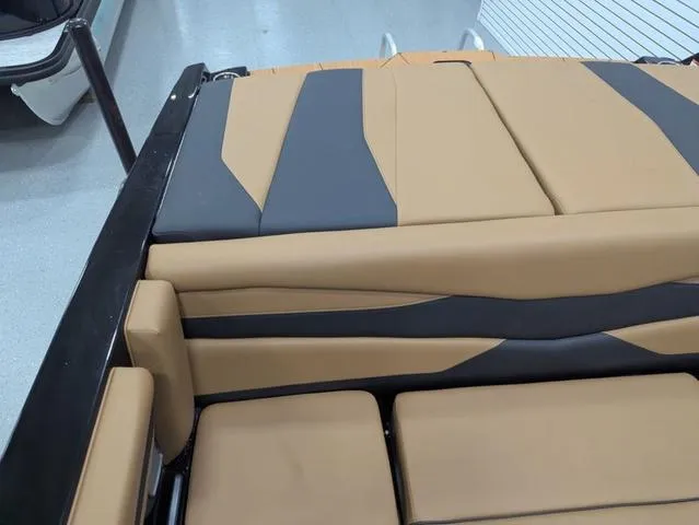 2025 Axis Wake Research A225 boat interior with tan and gray upholstery.