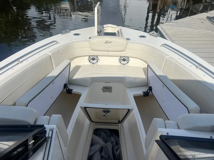  Yacht Photos Pics 2025 Scout 277 Dorado boat interior with spacious seating and storage, docked by the water.