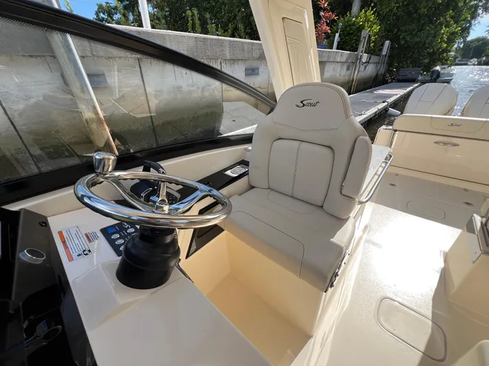  Yacht Photos Pics 2025 Scout 277 Dorado boat interior with steering wheel and comfortable seating.