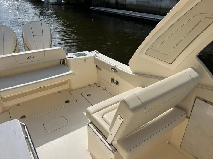  Yacht Photos Pics 2025 Scout 277 Dorado boat interior with beige seating and dual outboard motors.
