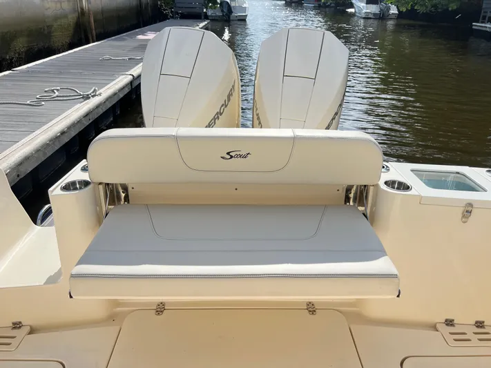  Yacht Photos Pics 2025 Scout 277 Dorado boat with dual Mercury engines, docked by the water.