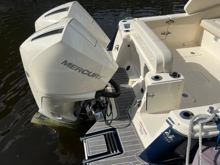  Yacht Photos Pics 2025 Scout 277 Dorado boat with dual Mercury outboard engines, docked on water.