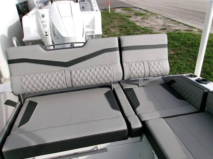  Yacht Photos Pics 2025 Monterey Elite 27 OB boat interior with gray and black cushioned seating.