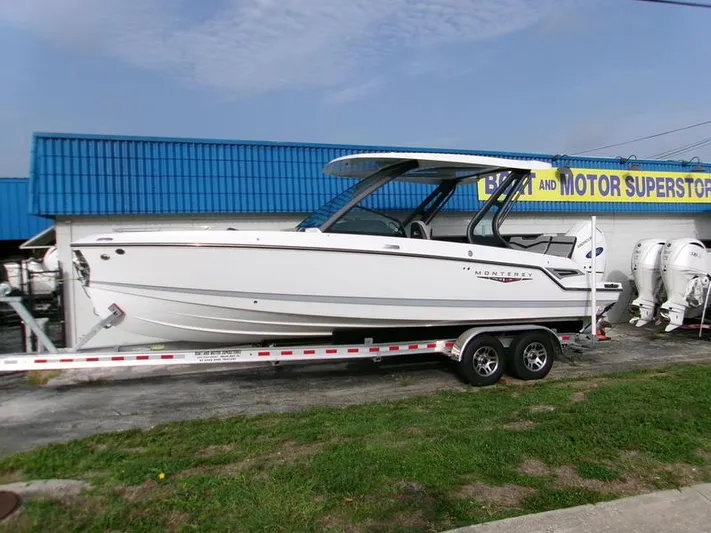  Yacht Photos Pics 2025 Monterey Elite 27 OB boat on trailer at dealership.