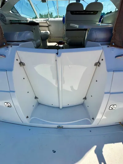  Yacht Photos Pics 2005 Doral Boca Grande boat interior with seating and table, featuring white and gray upholstery.