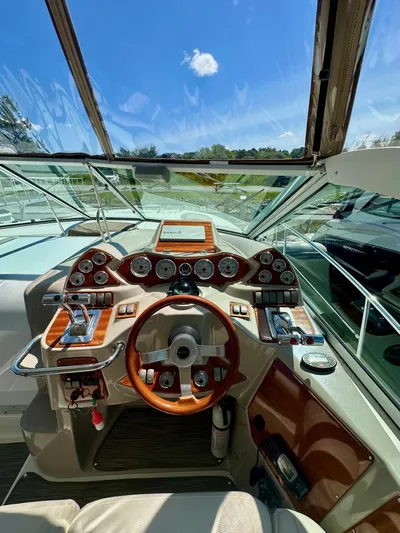  Yacht Photos Pics 2005 Doral Boca Grande boat dashboard with wooden steering wheel and gauges under clear blue sky.