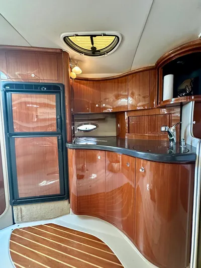  Yacht Photos Pics Luxurious 2005 Doral Boca Grande yacht interior with sleek wooden cabinetry and modern amenities.