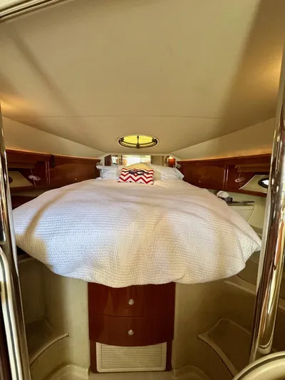  Yacht Photos Pics Luxurious cabin interior of a 2005 Doral Boca Grande yacht with cozy bedding.