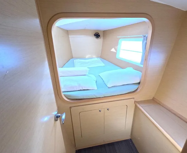 Kelapa Yacht Photos Pics Cozy cabin interior of 2016 Lagoon 380 S2 catamaran with bed and window.