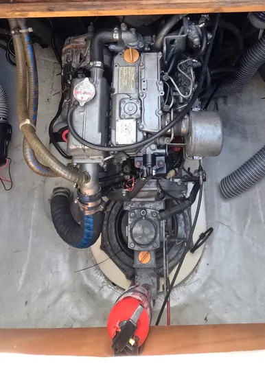 Kelapa Yacht Photos Pics Engine compartment of a 2016 Lagoon 380 S2 catamaran, showcasing mechanical components and hoses.