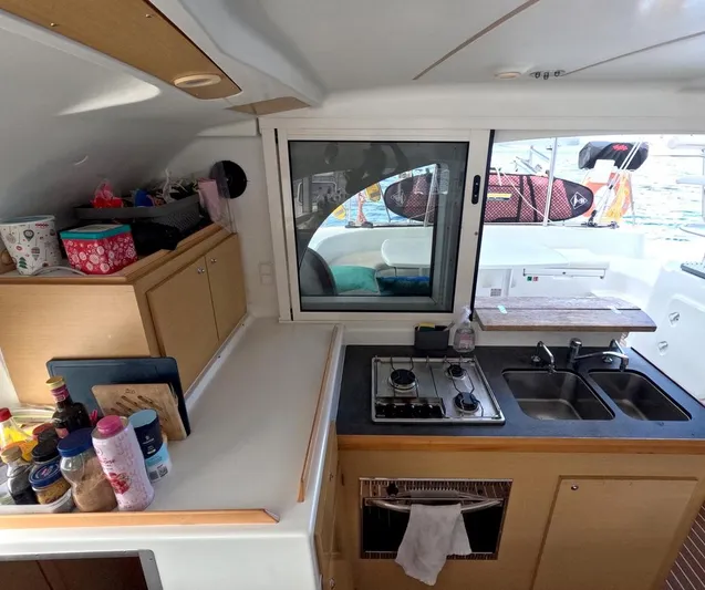 Kelapa Yacht Photos Pics Interior of 2016 Lagoon 380 S2 catamaran kitchen with stove, sink, and storage.