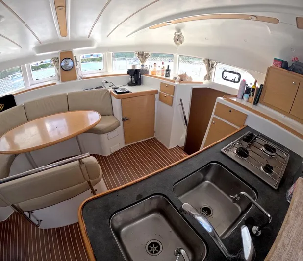 Kelapa Yacht Photos Pics Interior of 2016 Lagoon 380 S2 catamaran with kitchen and dining area.