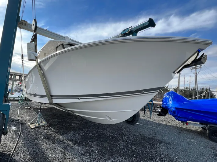  Yacht Photos Pics 2022 Pursuit S 358 boat on dry dock under blue sky.