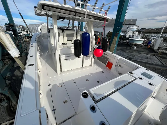  Yacht Photos Pics 2022 Pursuit S 358 boat interior with seating and fishing equipment.