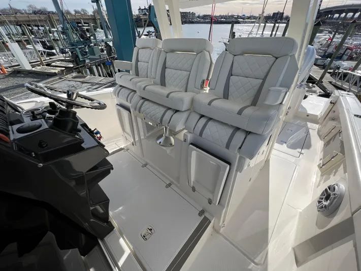 Yacht Photos Pics 2022 Pursuit S 358 boat interior with luxurious seating and helm controls.