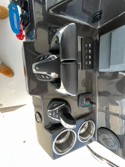  Yacht Photos Pics 2022 Pursuit S 358 boat dashboard with controls and cup holders.