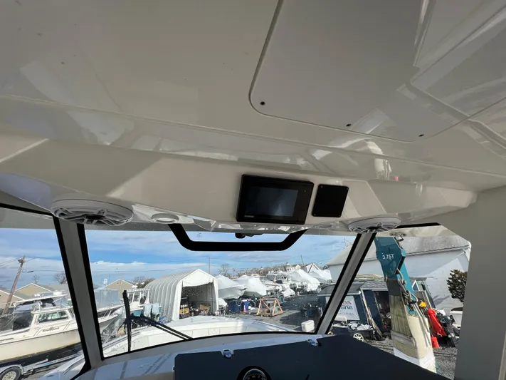  Yacht Photos Pics Interior view of 2022 Pursuit S 358 boat with dashboard and windows.
