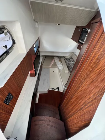  Yacht Photos Pics 2022 Pursuit S 358 cabin interior with wood accents and modern amenities.