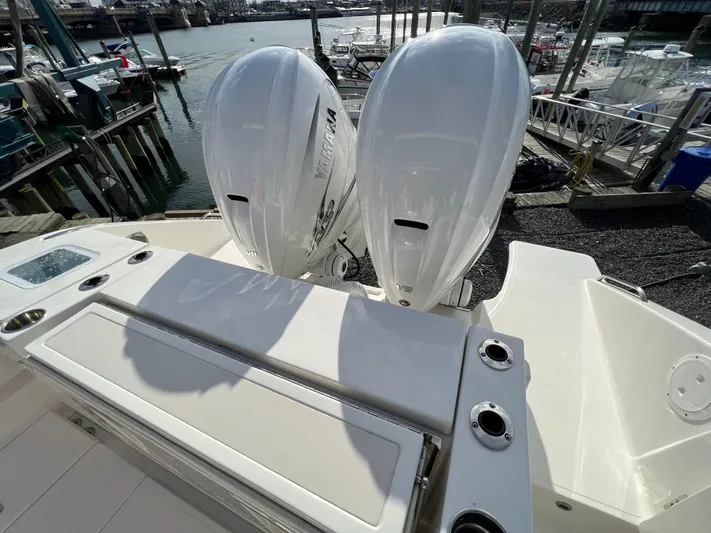  Yacht Photos Pics 2022 Pursuit S 358 boat with dual outboard engines at a marina.