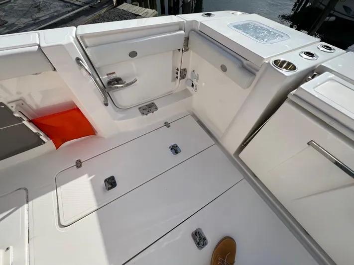 Yacht Photos Pics 2022 Pursuit S 358 boat deck with storage compartments and seating area.