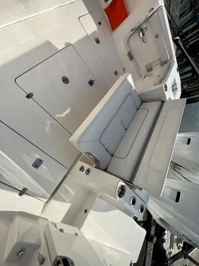  Yacht Photos Pics 2022 Pursuit S 358 boat interior with seating and storage compartments.