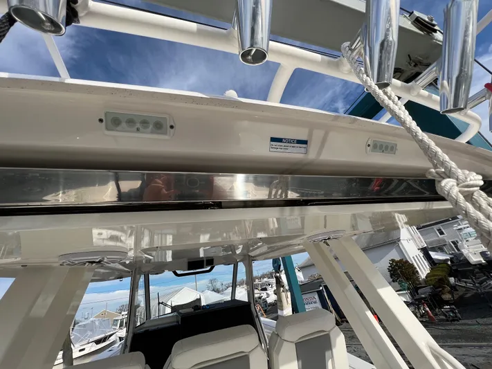  Yacht Photos Pics 2022 Pursuit S 358 boat interior with seating and overhead rod holders.