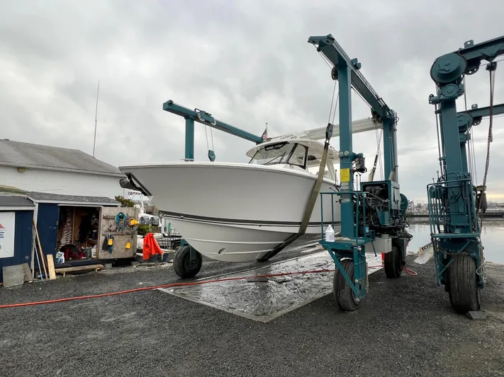  Yacht Photos Pics 2022 Pursuit S 358 boat on lift at marina dock.