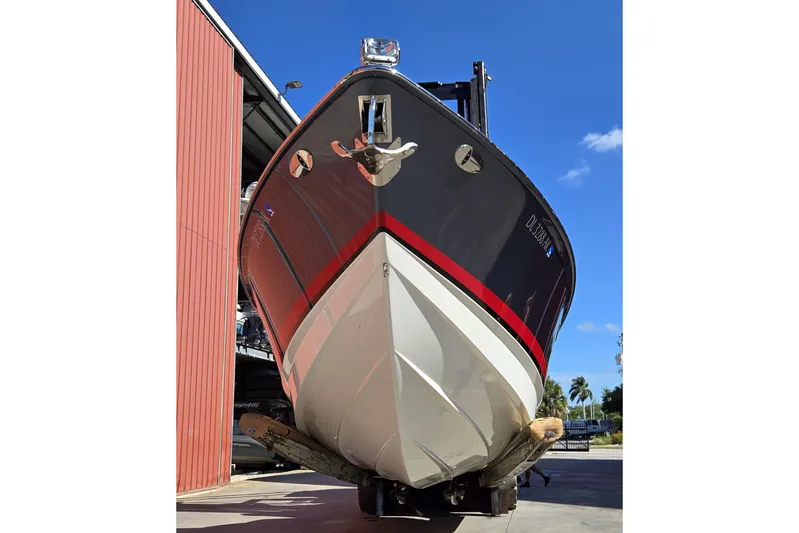 Famous Sport Boat Vibe Yacht Photos Pics 2016 Formula 330 Crossover Bowrider boat in dry dock, viewed from the front.