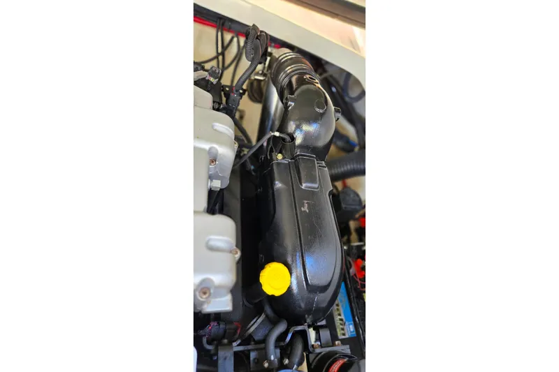 Famous Sport Boat Vibe Yacht Photos Pics Engine compartment of a 2016 Formula 330 Crossover Bowrider boat, featuring detailed components.