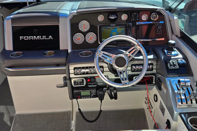 Famous Sport Boat Vibe Yacht Photos Pics Dashboard of a 2016 Formula 330 Crossover Bowrider with steering wheel and navigation controls.