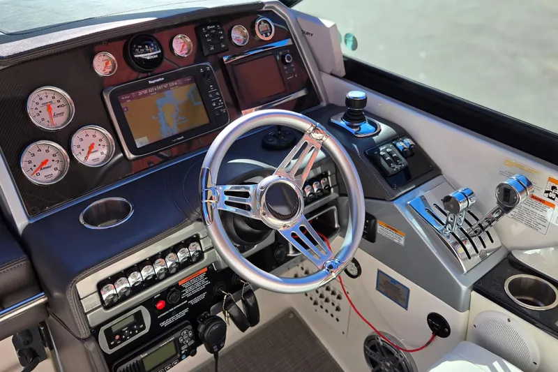 Famous Sport Boat Vibe Yacht Photos Pics Control panel of 2016 Formula 330 Crossover Bowrider with steering wheel and navigation instruments.