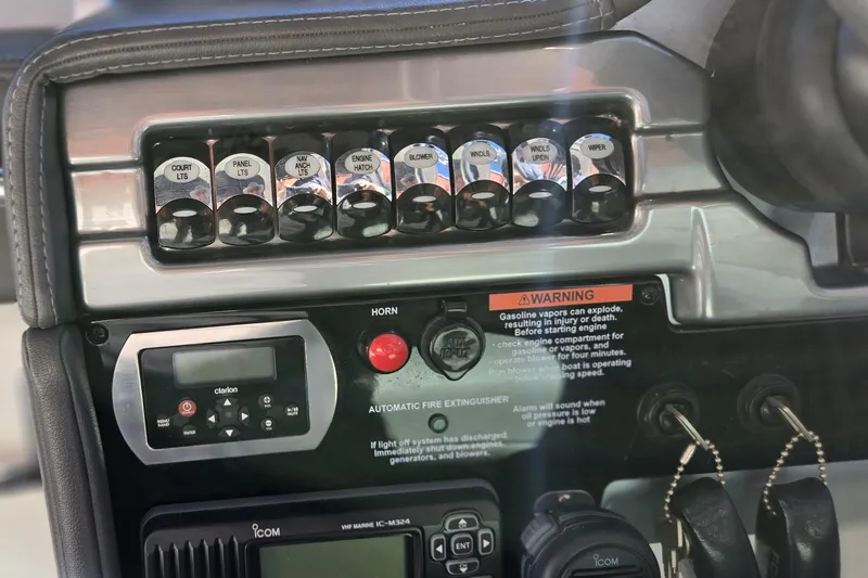 Famous Sport Boat Vibe Yacht Photos Pics Control panel of a 2016 Formula 330 Crossover Bowrider boat with switches and warning labels.