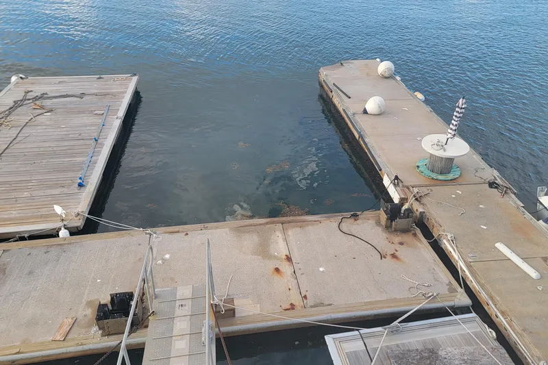  Yacht Photos Pics Floating marina docks with ropes and buoys on calm water, Custom model, 2003.