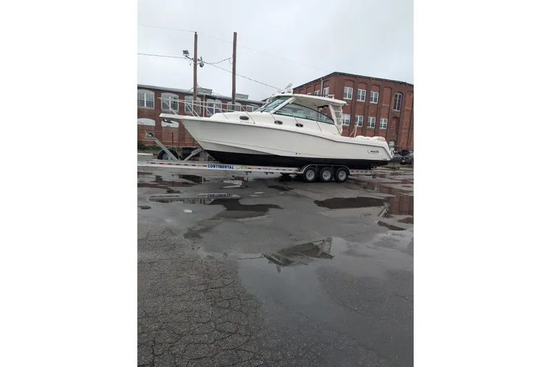 Amy Yacht Photos Pics 2018 Boston Whaler 245 Conquest boat on trailer in industrial area.
