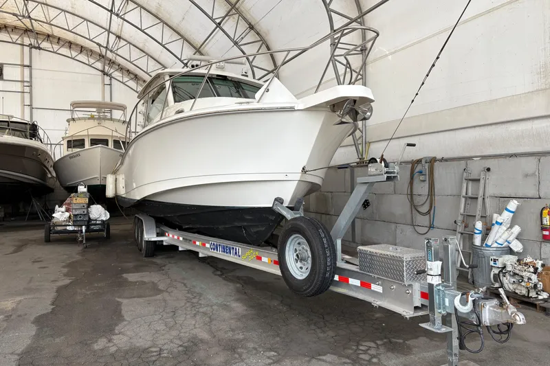 Amy Yacht Photos Pics 2018 Boston Whaler 245 Conquest boat on trailer in storage facility.