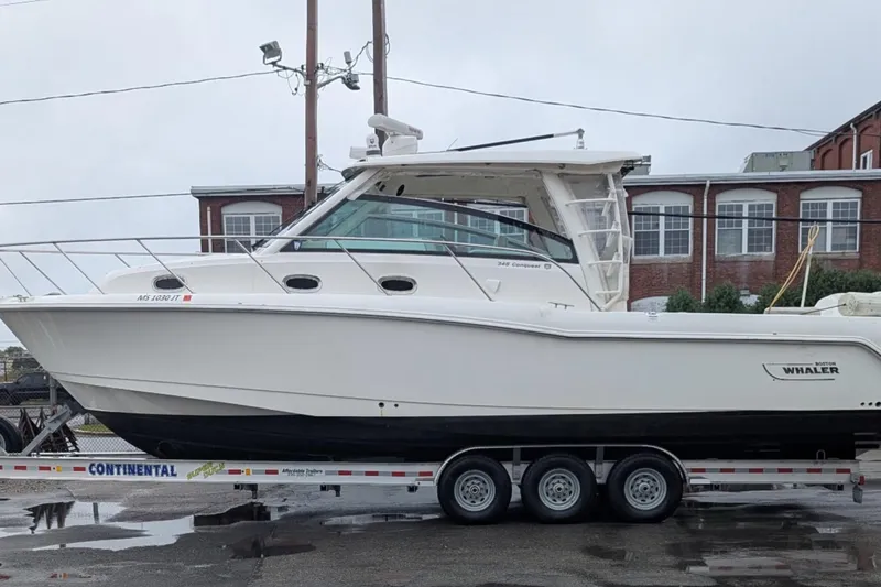 Amy Yacht Photos Pics 2018 Boston Whaler 245 Conquest boat on trailer, parked outdoors.