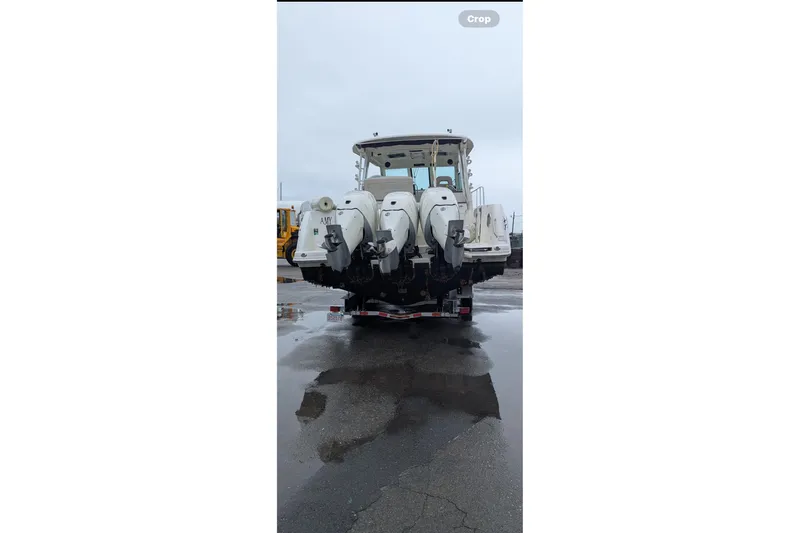 Amy Yacht Photos Pics 2018 Boston Whaler 245 Conquest boat with triple outboard engines on a trailer.