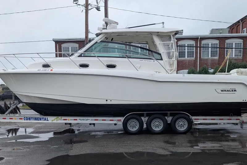 Amy Yacht Photos Pics 2018 Boston Whaler 245 Conquest boat on a trailer, parked outdoors.